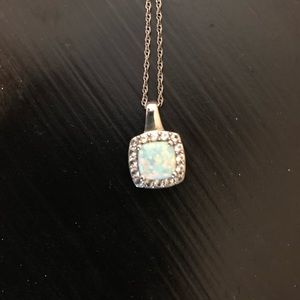 Opal necklace surrounded in diamonds.